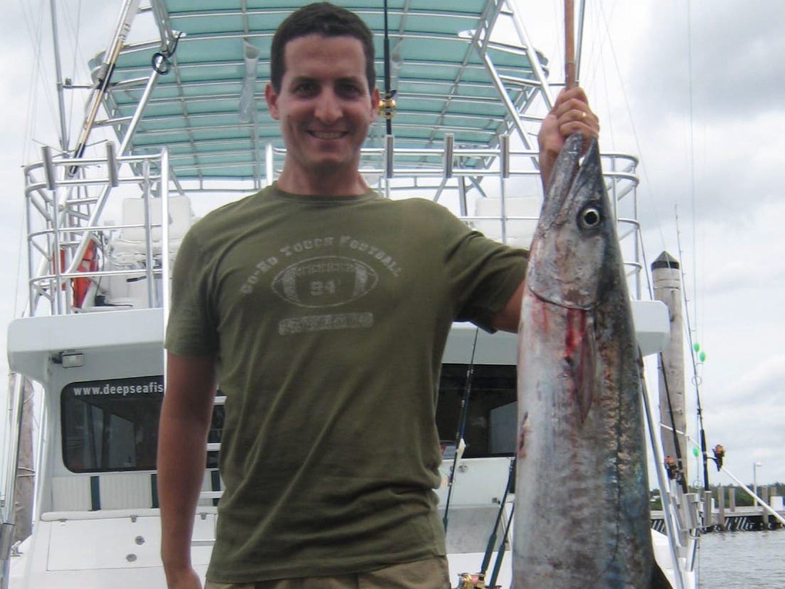 Angler with a kingfish caught aboard Spellbound, Miami