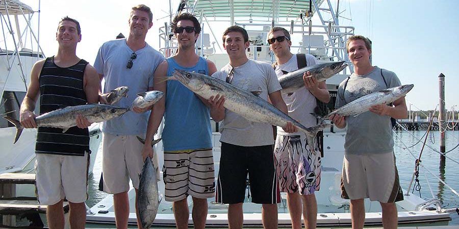Group of anglers with their kingfish catch dockside at Haulover Marina
