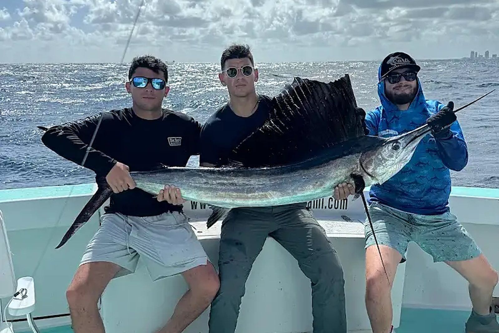 A bachelor party group with a sailfish aboard Spellbound, Miami