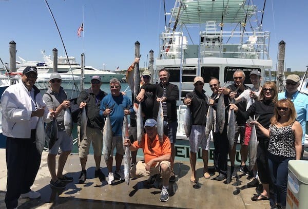 Large group of people showing their fish they caught