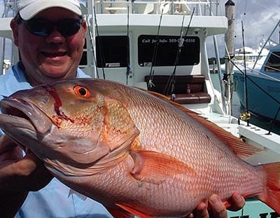 Happy fisherman with the Mutton He caught on a 3/4 day fishing charter